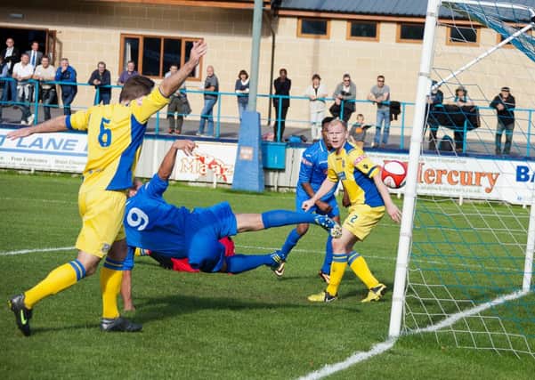 Danny Holland (no.9) scores against Frickley but his goal is disallowed. Below, Jon Kennedy saves late on. Photos by James Williamson.