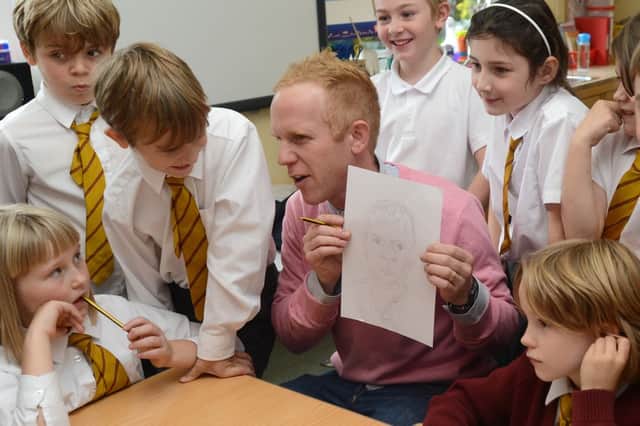 Artist Nick Hersey giving portrait drawing tips to year four at St Joseph's Primary