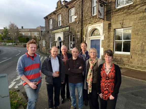 Pictured are members of a Bamford Community group outside the village pub The Anglers Rest