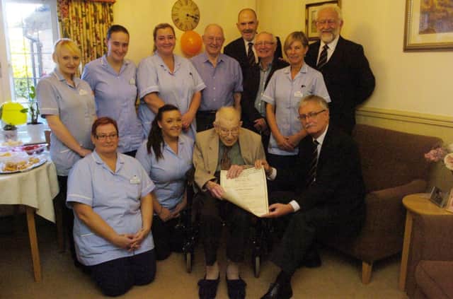 Bakewell Cottage Nursing Home Resident Robert Bedlington recieves a certificate celebrating 50 years as a Freemason from members of Bakewell Freemasons.