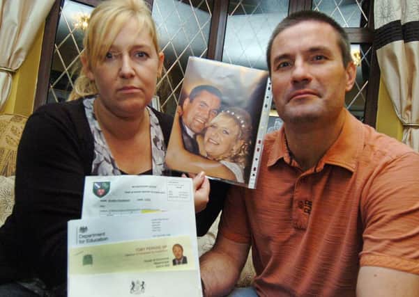School fines Staveley Parents. Mandy and Dean Smith with letters and wedding picture.