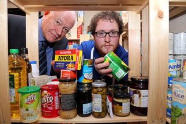 Derbyshire County Council Cabinet Member for Health and Communities Councillor Dave Allen (left) takes a look around The Gates Foodbank in Chesterfield with project manager Ben Martin.