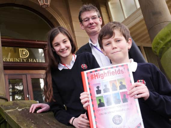 CHIEF EDITORS: Pupils Isabella Edwards, 11, and Jack Lloyd, 11, with Councillor Andy Botham and their winning magazine at County Hall, Matlock.