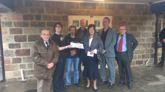 MP Pauline Latham is presented with a petition by Emily Bowler of the Pattenmakers Arms