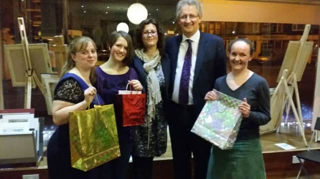 Winners of the Buxton Town Team Christmas Crawl - High Peak MP Andrew Bingham and Rachel Hoodith of Minibugs Boutique with  Danielle Watson 3rd prize winner red bag) , Caireen Hargreaves 2nd
 Prize Winner, (Silver Bag) , and Karen Jones, on behalf of 1st Prize Winner Lindsay Jones (Gold Bag).