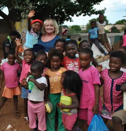 Glossop's Lisa Ashton, centre, of the Winnie Mabaso Foundation, helping orphans in South Africa. Photo contributed.