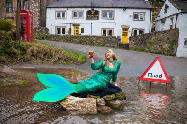 Mermaid Liz Stoppard making the most of flooding in Derbyshire, visiting the usually land locked Barley Mow pub in Bonsall. The road and car park outside the pub has been flooded for several weeks.