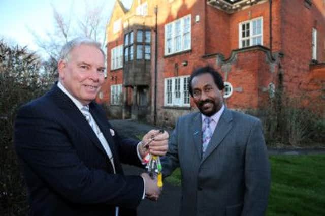 Cllr Brian Ridgway, left, hands over the keys to St Helena Centre to Hari Punchihewa, from the University of Derby