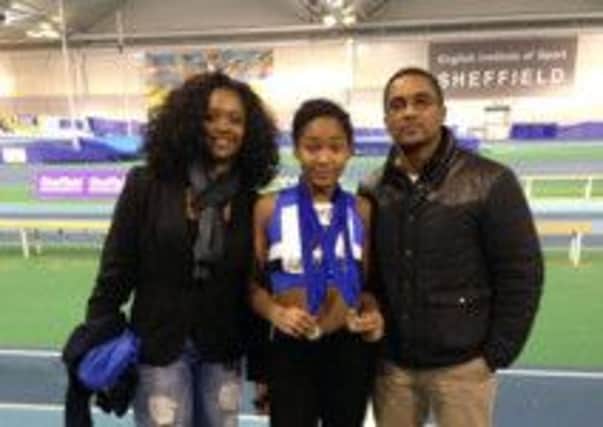 Pictured is promising athlete Nazhrah Simpson, of Chesterfield, with mum Tanya Simpson and and step-dad Robert MacKay after she won two gold medals at the Northern Athletics Indoor Under 13s Champoionships.