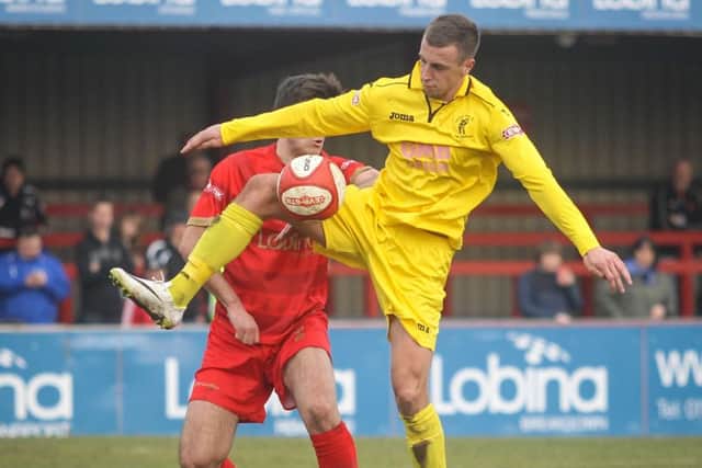 Pictured shielding the ball is Matlock Town FC's Shaun Tuton who scored the third goal against Ilkeston.