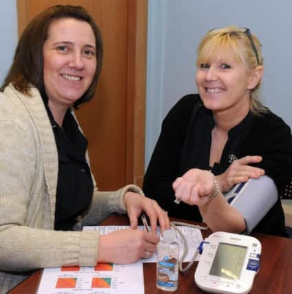 Health First CLC business manager Sharon Sargent with Denise Hallworth having a health check at The Galleries Wigan
