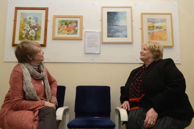 Artists Doreen Ball and Norma Creed in the mini gallery at Glossop station's waiting room