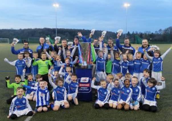 Chesterfield Junior Blues celebrate a Johnstone's Paint Trophy tour visit at Brookfields Community School before the Spireites' Wembley cup final on March 30.