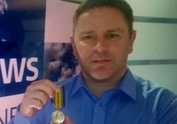 ITV reporter Kenny Toal with Belper man Herbert Butler's Victory Medal