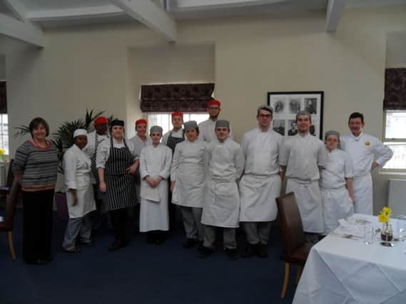Lecturers Sandra Cooper and Rob Stordy in the University of Derby's Fine Dining Restaurant with some of the students who passed the new qualification. Photo contributed.