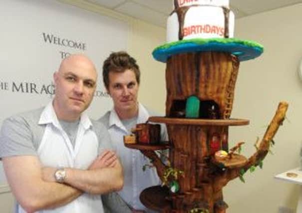 Feature on The Mirage Cake Company in Heanor. Pictured is owner Jamie Brooks (left) with nephew Joseph Blackhall. with nephew Joseph Blackhall with award winning fairytale tree cake.