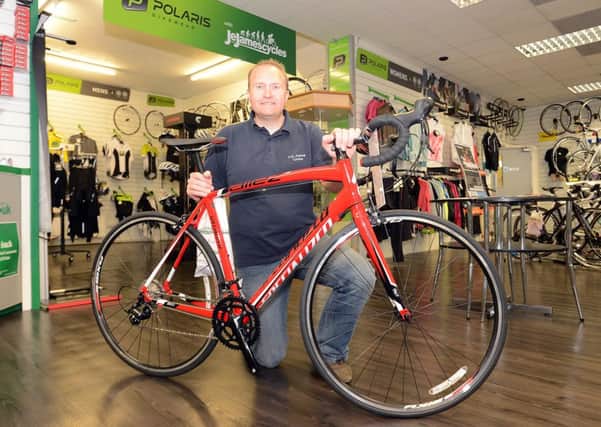 JE James cycles Chesterfield. Red Specialised bike that is being raffled for the Derbyshire Times Flag Challenge for Ashgate Hospice. Michael Burr asst manager.