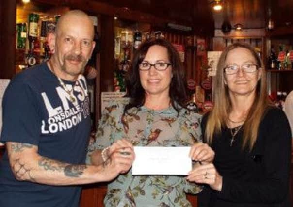 Pictured is Ian and Anna Roscoe, of the Wheatsheaf Inn, Newbold, Chesterfield, presenting this years donation of £750 to Ashgate Hospices Chief Executive Lucy Nickson.