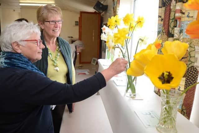 Sparrowpit WI show, flower judge Ann Mayo and president Maggie Bristow examine the entries