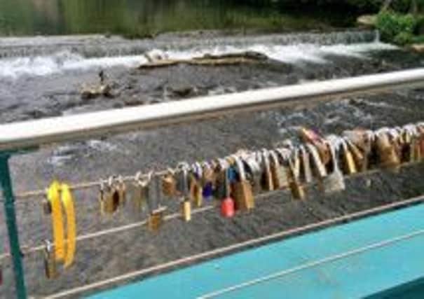 'Love locks', padlocks inscribed which a couple's intials, on a bridge in Bakewell. Photo by Emma McClarkin.