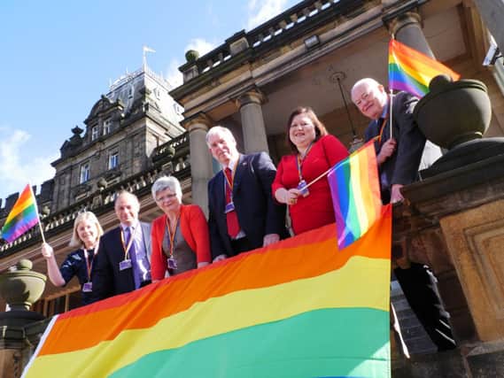 Flying the flag: Derbyshire County Council's Cabinet members show their support for the International Day Against Homophobia and Transphobia.