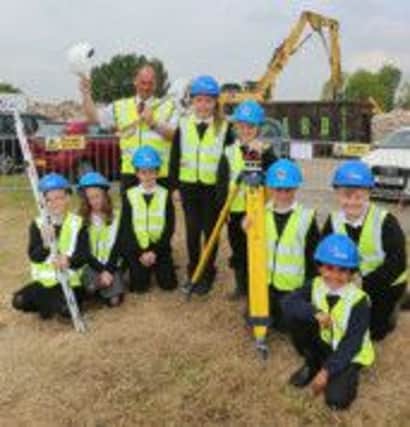 SPADEWORK: Councillor Kevin Gillott, the county council's Deputy Leader and Cabinet Member for Children and Young People, on the site of the new North Wingfield Primary School with current pupils: (left to right) Georgie Lampkin,10, Tarryn Savidge,10, Korey Turner, 9, Paige Keetley, 10, Charlie Elliott, 9, Stanley Pashley, 9, Danny Grattage, 10 and Ryan Ireing, 9.