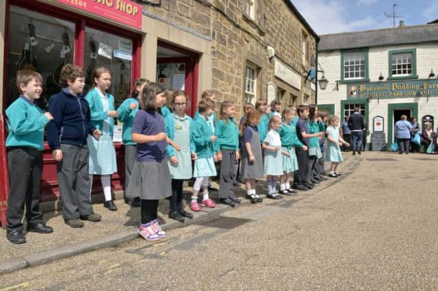 Children from Curbar Primary School choir singing on the streets of Bakewell to raise money for a Multi-Use Games Area at the school