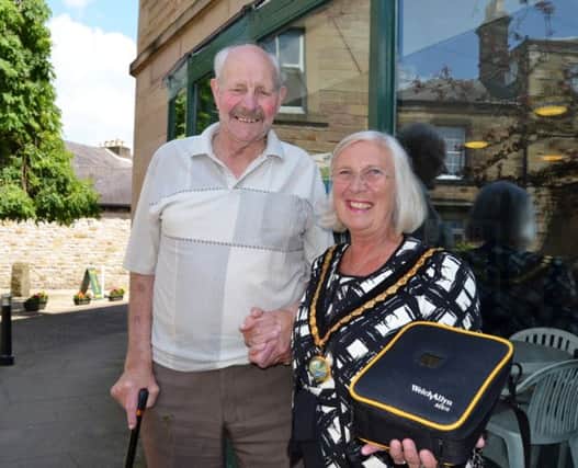 David Berrecloth with Chairman of the District of the Derbyshire Dales Councillor Carol Walker and the life-saving defibrillator