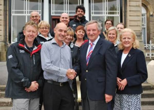 Andrew Pugh, outgoing Chairman of Visit Peak District & Derbyshire (front row, third from left), receives warm thanks from interim Chairman Paul Roden (front row, second from left) at the Palace Hotel, Buxton. Also pictured are Vanessa Pugh (front row, right), David James, Chief Executive of Visit Peak District & Derbyshire (front row, left) and the Visit Peak