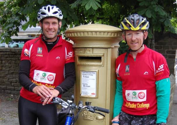 Lucas Meagor and Chris Britton, pictured in Chapel-en-le-Frith, cycled 2,800 miles visiting all 100 post boxes painted gold during the 2012 London Olympics. Photo contributed.