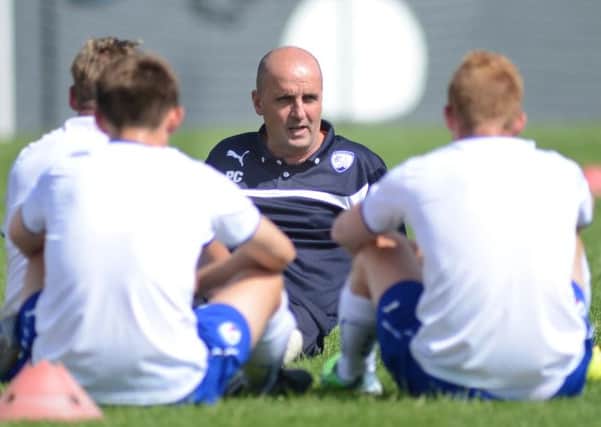 Paul Cook talks to his players at half time