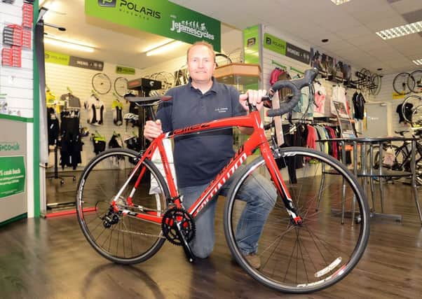 JE James cycles Chesterfield. Red Specialized bike that is being raffled for the Derbyshire Times Flag Challenge for Ashgate Hospice. Michael Burr asst manager.