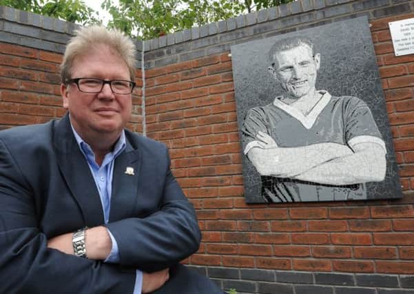 Partial unveil of new memorial at Chesterfield FC, pictured here is Phil Tooley with artwork of David Blakey, an ex player who died this year.