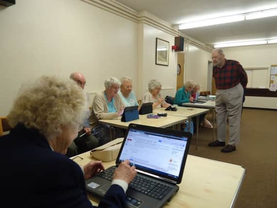 Roy Tomlin, 93, helps out at the Comfortable with Computers session.