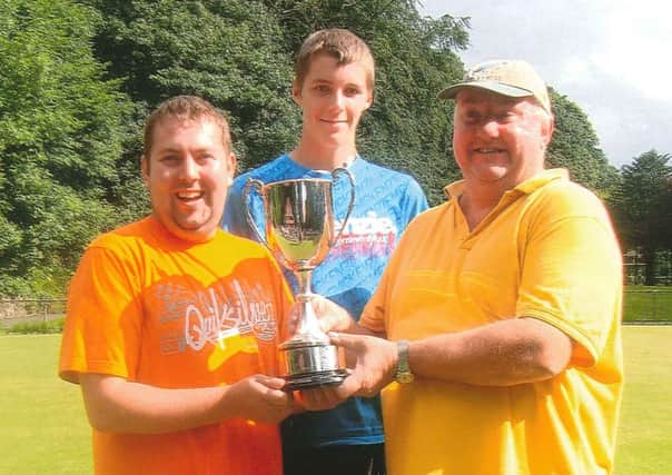 Buxton & District Bowling Association League Competitions Secretary Callum Briddon presenting the Jack Hitchings Cup to John and Danny Golpin. Photo contributed.