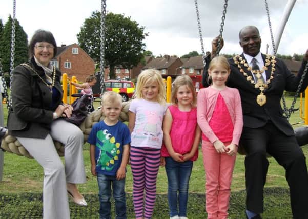 Chesterfields mayoress, Mrs Vickey-Anne Diouf, Daniel (3), Devon (5), Lucy (5), Georgia (7) and Chesterfields mayor, Councillor Alexis Diouf with the new play equipment at Kirkstone Road Park.