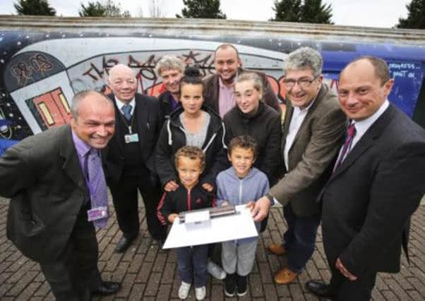 From left to right - Back row: Andrew Bott, Derbyshire County Council;  Cllr Roy Walker;  Neil Onyon, Youth Worker Derbyshire County Council;  Mark Robinson CEO of Scape;  Paul Smith, Derbyshire County Council;  Cllr Kevin Gillott Front row: Tasha Cooper and Estelle Bradley with Levi and Lucian Chambers.