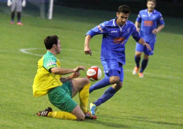 Josh Meade (right) gets forward for Matlock as Eddie Nisevic dives in to tackle. Photo by Eric Gregory.