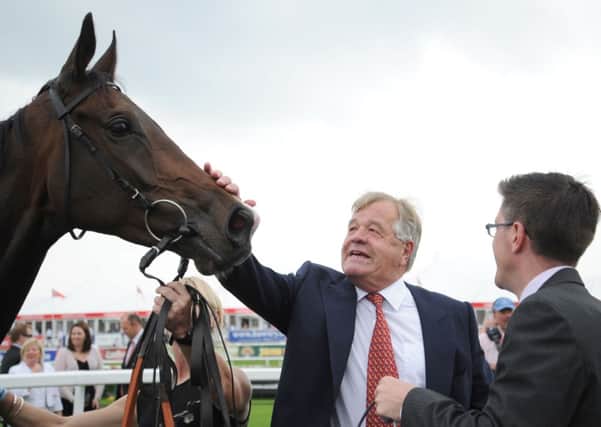 SIR MICHAEL STOUTE (centre), who trains today's Tip Of The Day (PHOTO BY: Anna Gowthorpe/PA Wire).