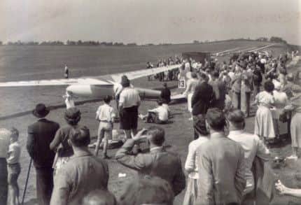 Buxton Advertiser archive, 1954, Great Hucklow hosted the world gliding championships, the crowd watches a dutch competitor take off