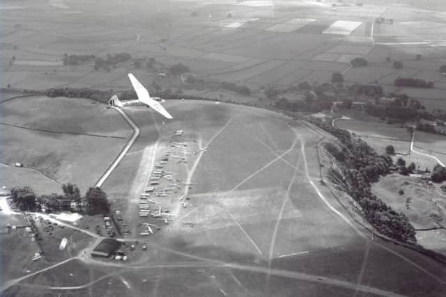 Buxton Advertiser archive, 1954, Great Hucklow hosted the world gliding championships, a french competitor above the launch field