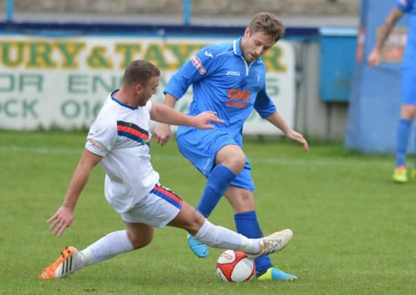 Matlock midfielder James Ashmore (right) is challenged by a Whitby defender on Saturday.