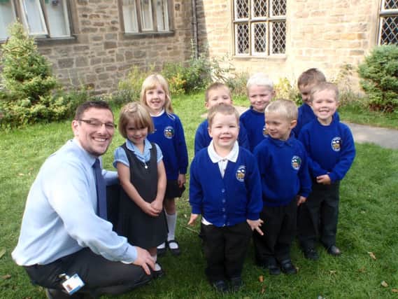 Iain Wilson with a group of children at the school.