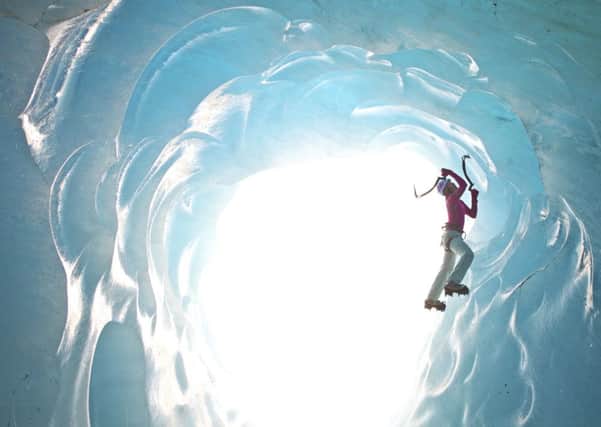 Stephanie Maureau climbing in an ice cave under the Mer de Glace glacier, France