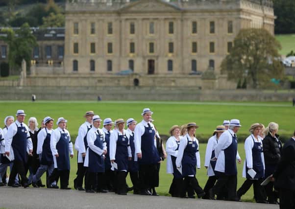 Chatsworth House staff walk into position along the route leading to the Church. The funeral for the Dowager Duchess of Devonshire at Chatsworth House today October 2 2014. Over 600 staff and thousands of public lined the drive leading to Chatsworth House to pay their respects to the Dowager. 
Tom Maddick / Rossparry.co.uk
