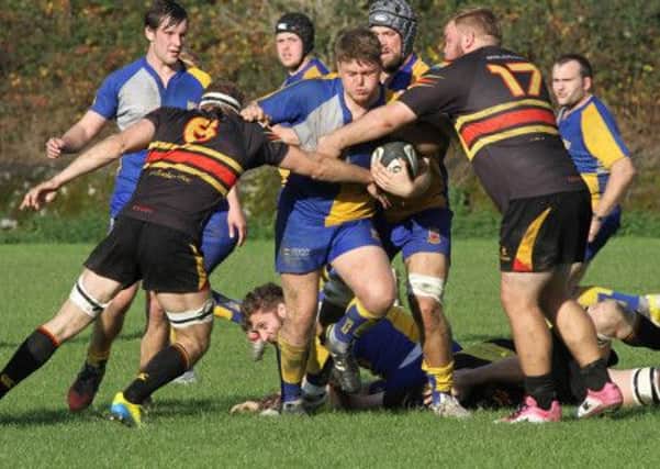 Simon Wright of Matlock RFC gets surrounded during the game with West Bridgford. Photo by Colin Baker.