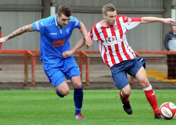 Matlock defender Joe Leesley pursues Danny Andrews. Photo by Nick Jones/Mid-Cheshire Guardian.