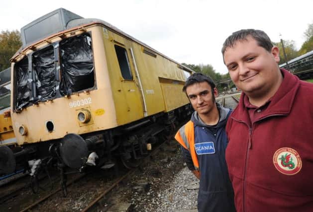 Restoration team at Ecclesbourne Valley Railway is appealing for help to restore old train (pictured behind). Pictured is Joe Marsden and Leigh Gration.