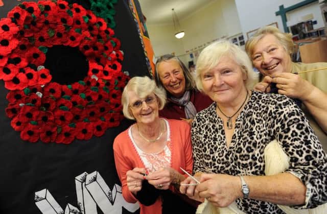 Knit and Natter group at Wirksworth Library have collectively knitted a giant poppy. Pictured l-r is Christine Stone, Carol Lewis, Judy Bunting and Jeannette Taylor.