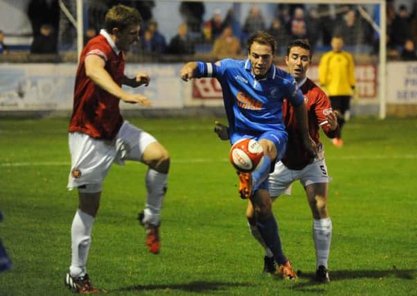 Danny Holland in action for Matlock against FC United on Tuesday night. Photo by Lizzi Lathrop.